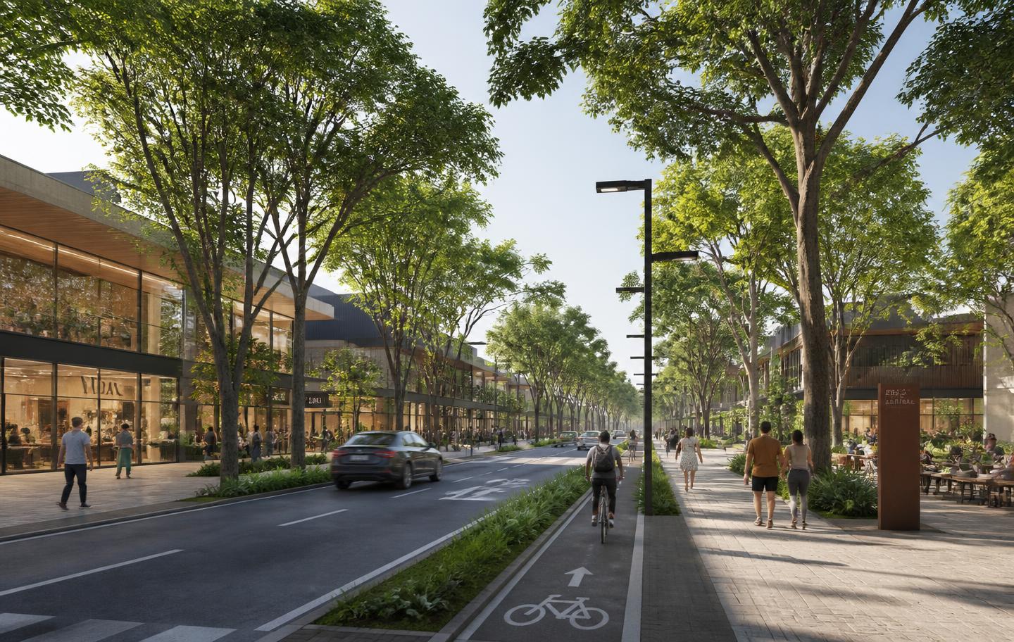 Avenida arborizada do bairro planejado com lojas e calçadas amplas